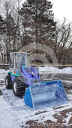 Backhoe to excavate the snow in ground Stock Photo